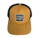 Acorn cap with black mesh back and 'Spread a Little Sunshine' text on a white background